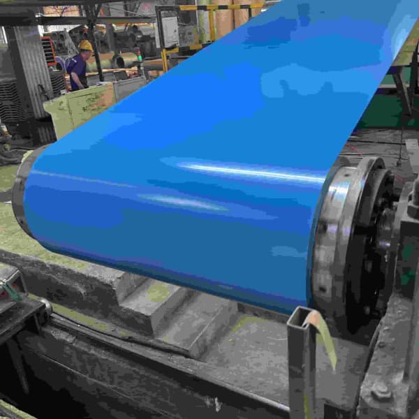Continuous automated paint baking oven processing a prepainted galvanized steel coil sheet.
