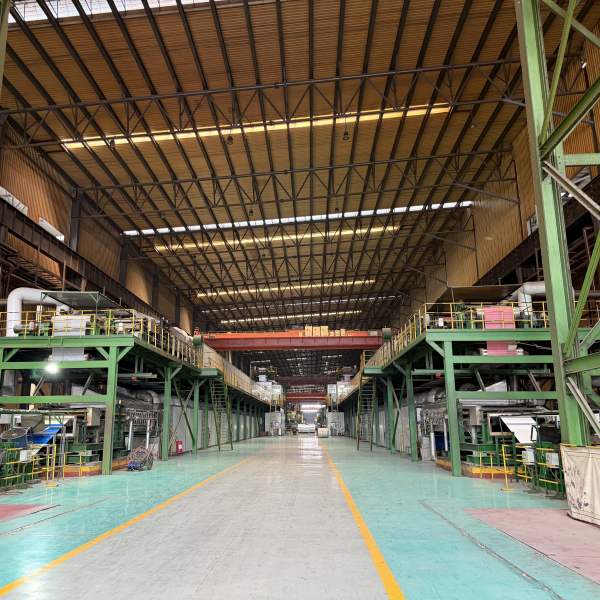Authentic Steel warehouse filled with high-quality prepainted steel coil rolls ready for shipment.