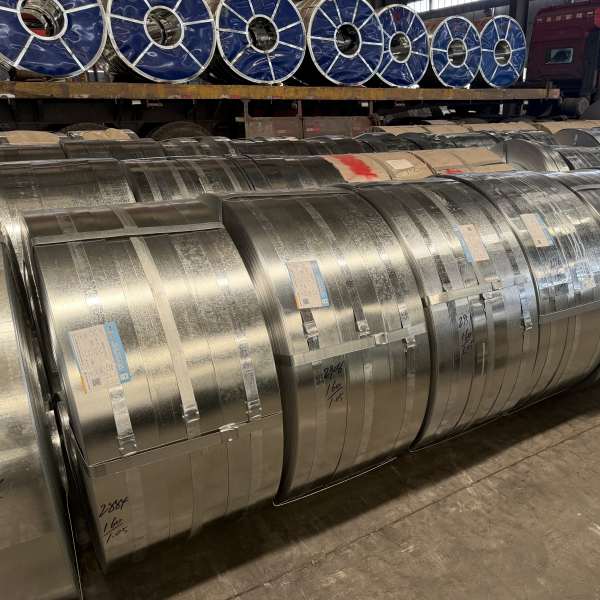 Steel strip coil being uncoiled into a pipe welding machine