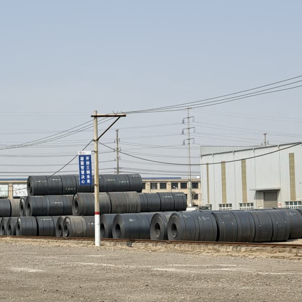 Crane loading checkered hot rolled steel coils at Tianjin dock